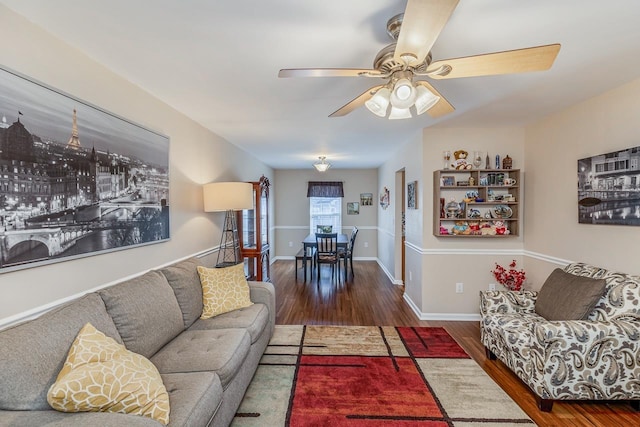 living room with ceiling fan and dark hardwood / wood-style floors