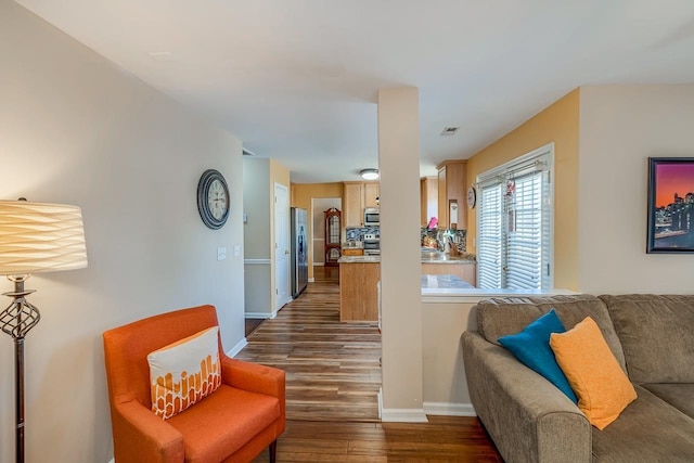 living room featuring dark wood-type flooring