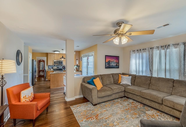 living room featuring ceiling fan and dark wood-type flooring