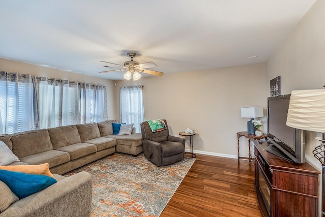 living room featuring dark hardwood / wood-style floors and ceiling fan