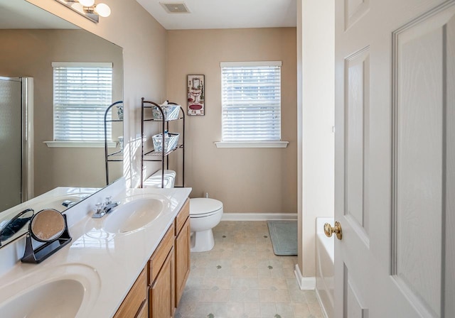 bathroom featuring an enclosed shower, plenty of natural light, toilet, and vanity