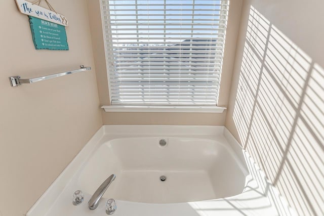 bathroom with a bathtub and a healthy amount of sunlight