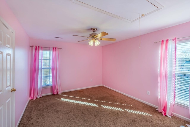 carpeted empty room featuring ceiling fan and a healthy amount of sunlight