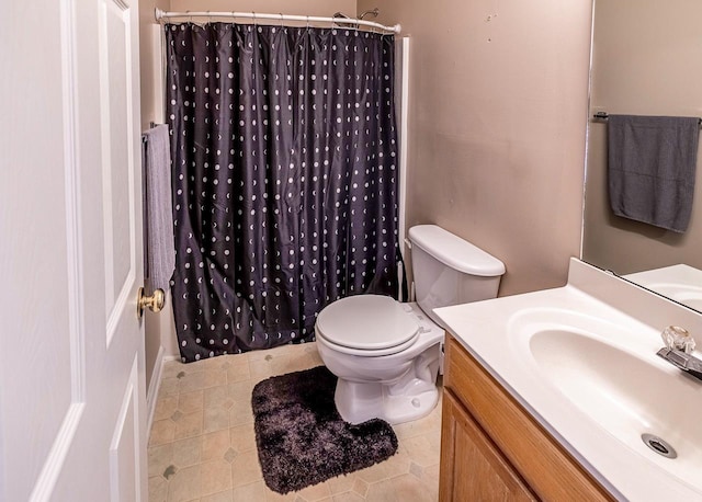 bathroom with toilet, vanity, tile patterned floors, and walk in shower