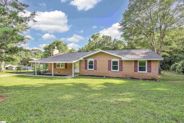 ranch-style house featuring covered porch, a front yard, and a carport