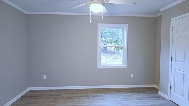 spare room featuring ceiling fan, light wood-type flooring, and crown molding