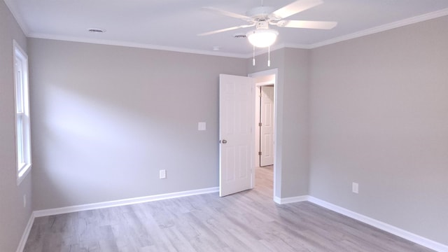 spare room featuring light hardwood / wood-style floors, ceiling fan, and ornamental molding