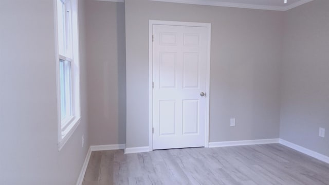 unfurnished bedroom featuring light hardwood / wood-style flooring and ornamental molding