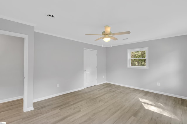 empty room with crown molding, ceiling fan, and light hardwood / wood-style floors