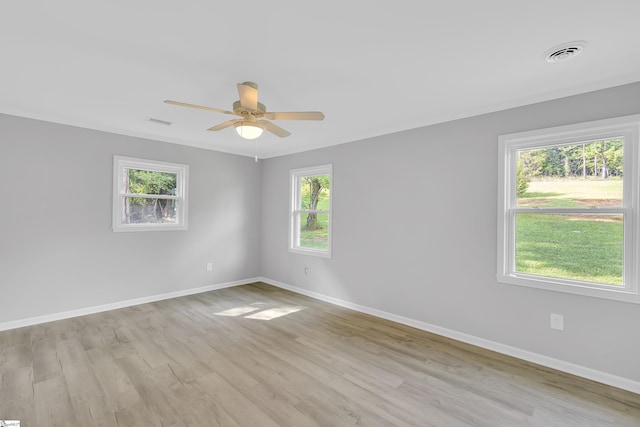 spare room featuring ceiling fan, plenty of natural light, and light hardwood / wood-style floors