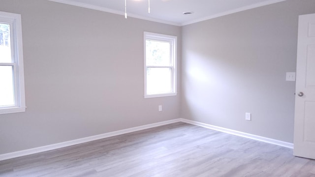 unfurnished room with crown molding and light hardwood / wood-style floors