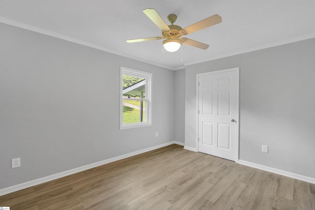 spare room with ceiling fan, light wood-type flooring, and crown molding