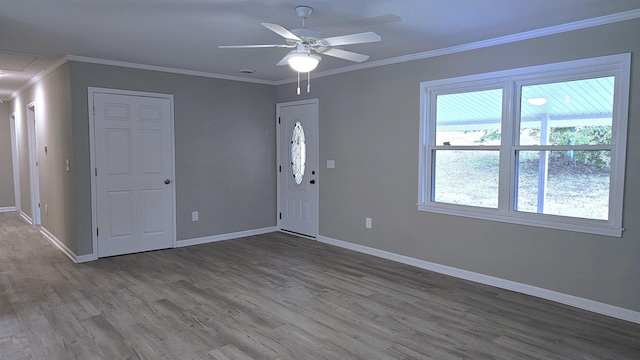 spare room featuring hardwood / wood-style floors, ceiling fan, and ornamental molding