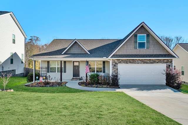 view of front of home with a garage, covered porch, and a front yard