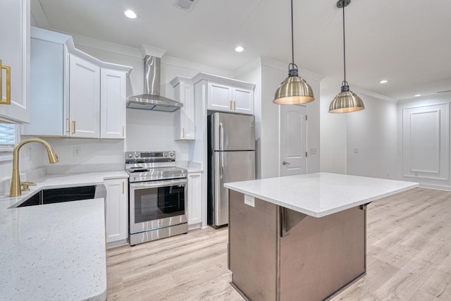 kitchen with stainless steel appliances, sink, wall chimney range hood, a center island, and white cabinetry