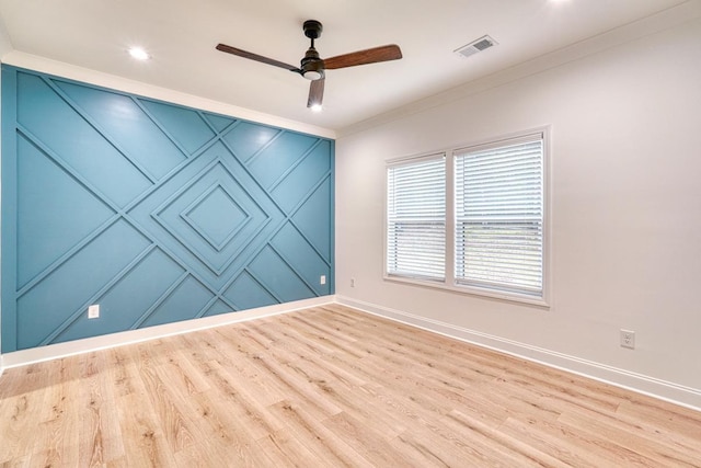 empty room with light hardwood / wood-style floors, ceiling fan, and crown molding