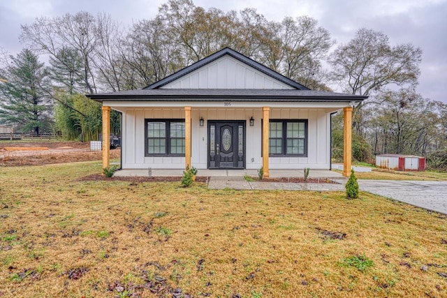 view of front of home with a porch and a front lawn