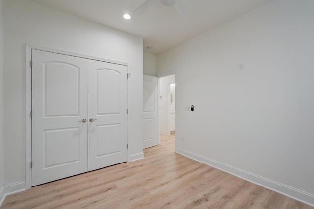 unfurnished bedroom with a closet, ceiling fan, and light hardwood / wood-style flooring