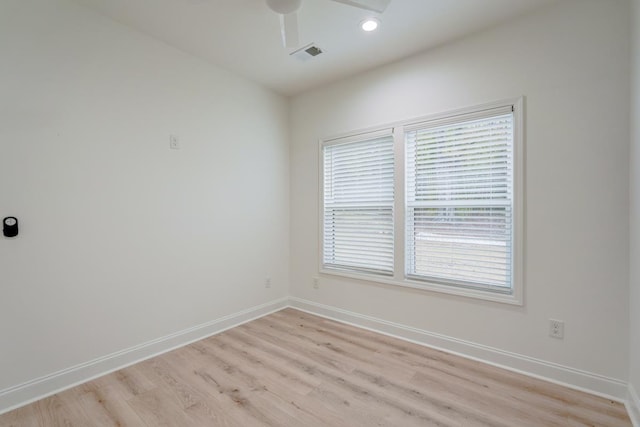 spare room with light hardwood / wood-style flooring and ceiling fan