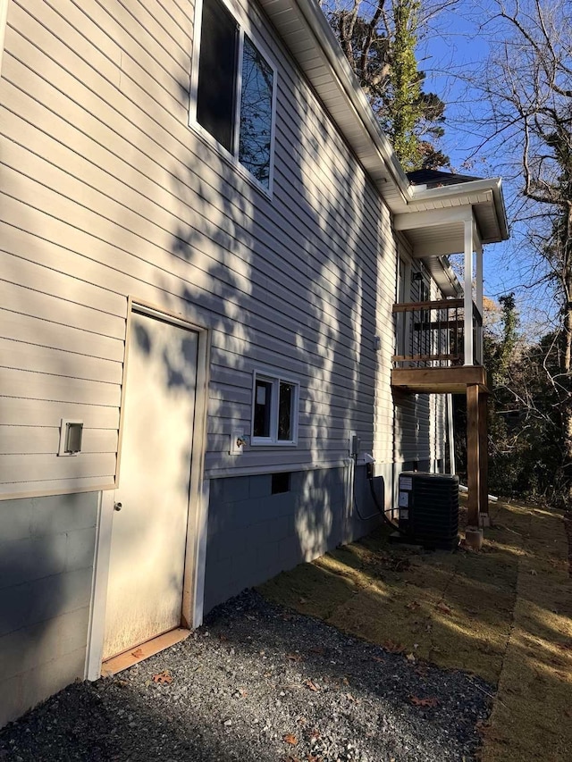 view of home's exterior featuring a balcony and cooling unit