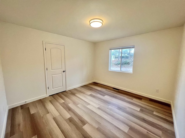 unfurnished room featuring light wood-type flooring