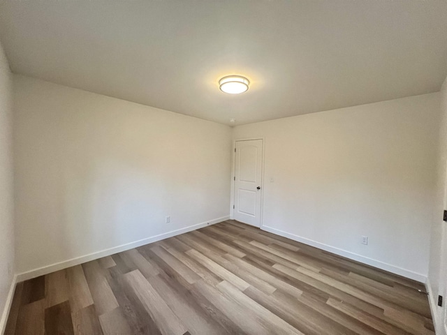 unfurnished room with hardwood / wood-style floors