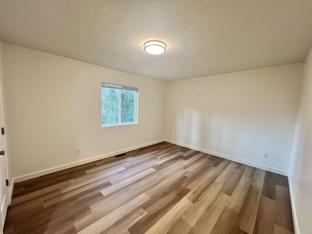 spare room with light hardwood / wood-style flooring