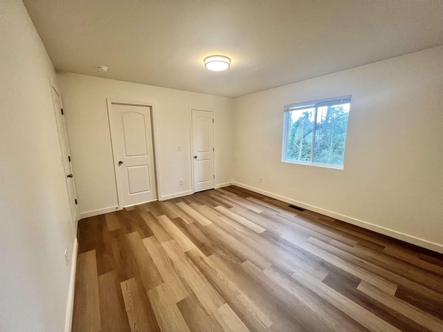 empty room featuring hardwood / wood-style flooring