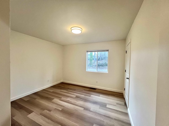 empty room with light hardwood / wood-style floors