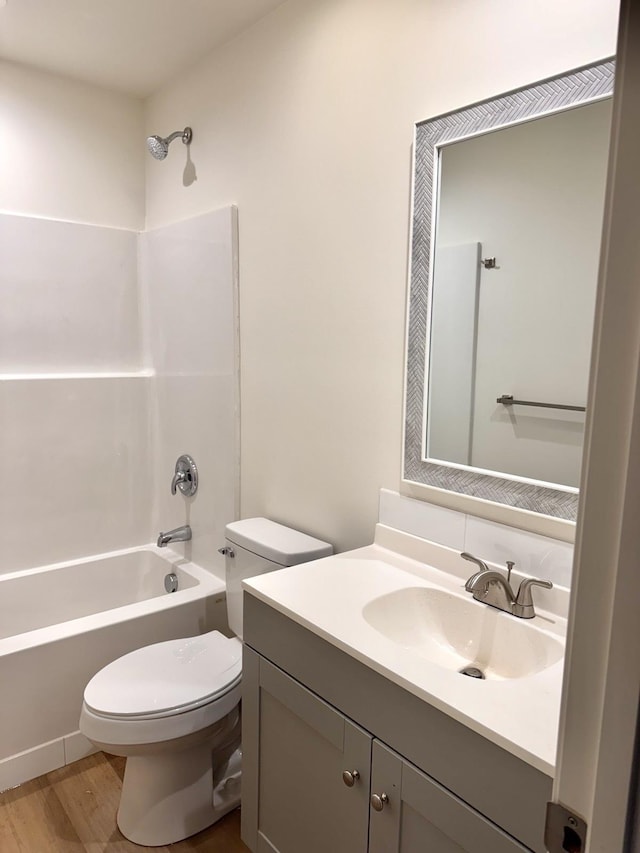 full bathroom featuring bathtub / shower combination, wood-type flooring, vanity, and toilet