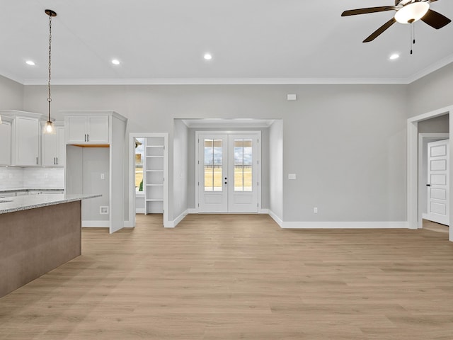 unfurnished living room featuring ceiling fan, light hardwood / wood-style flooring, french doors, and ornamental molding