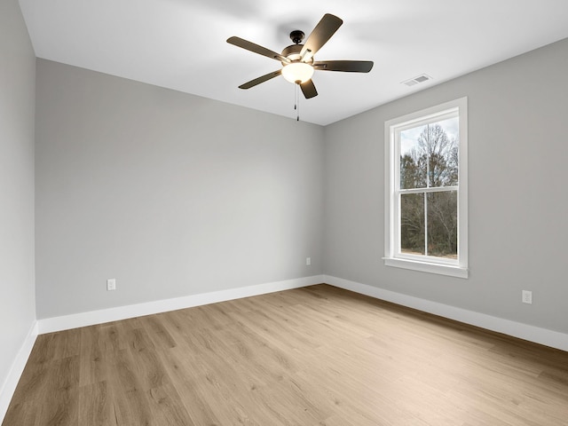 empty room with ceiling fan and light hardwood / wood-style floors