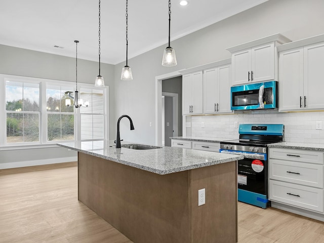 kitchen featuring white cabinetry, an island with sink, and appliances with stainless steel finishes