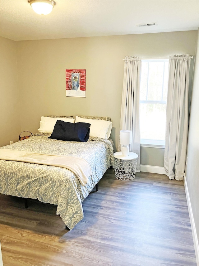 bedroom with hardwood / wood-style flooring