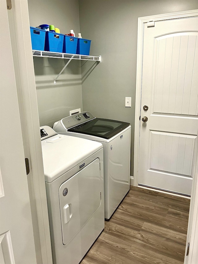 washroom featuring hardwood / wood-style flooring and separate washer and dryer