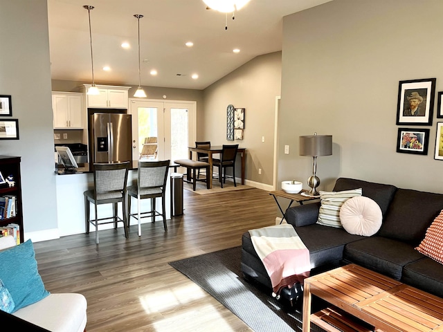 living room featuring hardwood / wood-style flooring and lofted ceiling