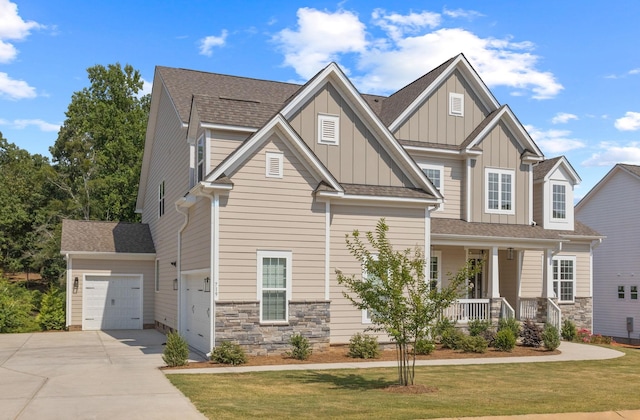 craftsman-style house with a front yard, a porch, and a garage