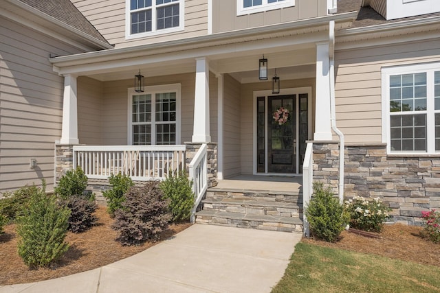 view of exterior entry with a porch