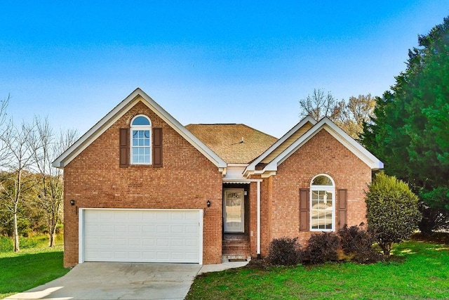 view of front of property with a front yard and a garage