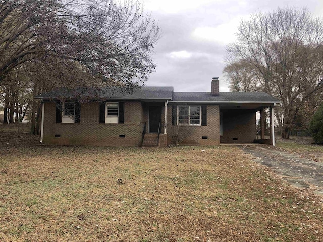 ranch-style house with a carport and a front lawn