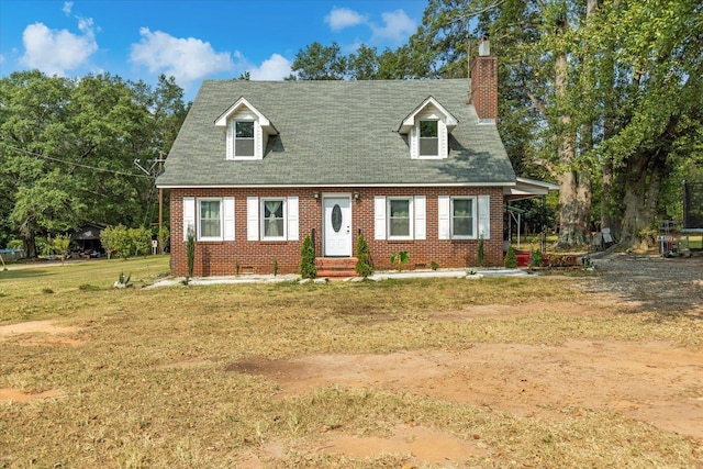 cape cod house with a trampoline and a front lawn