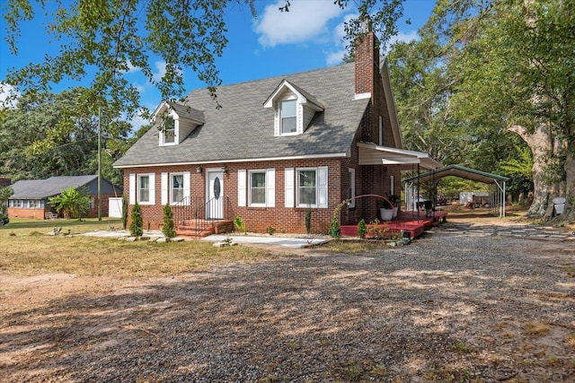 cape cod home featuring a carport