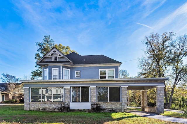 view of front facade with a front yard and a carport