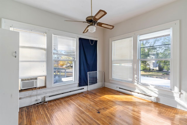 spare room with hardwood / wood-style floors, ceiling fan, cooling unit, and a baseboard heating unit