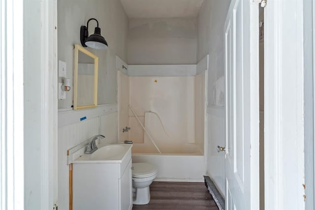 full bathroom with bathing tub / shower combination, toilet, vanity, and hardwood / wood-style flooring