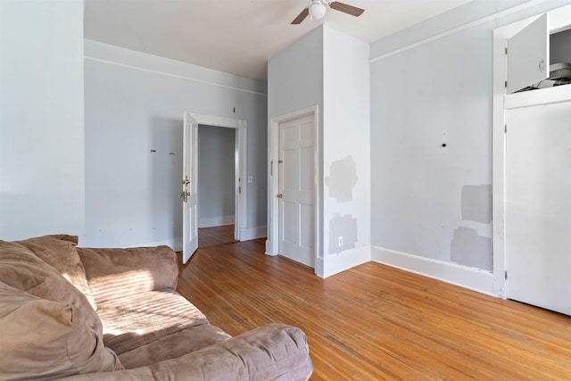 living room with hardwood / wood-style flooring and ceiling fan