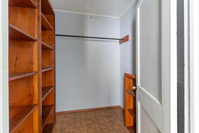 spacious closet with dark parquet floors