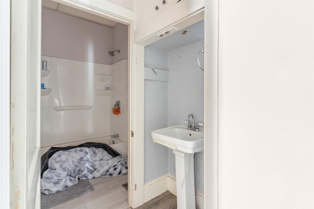 bathroom featuring hardwood / wood-style flooring, sink, and walk in shower