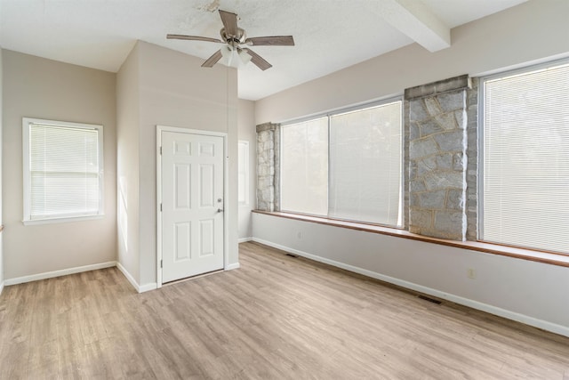 interior space with ceiling fan, light hardwood / wood-style floors, and beam ceiling