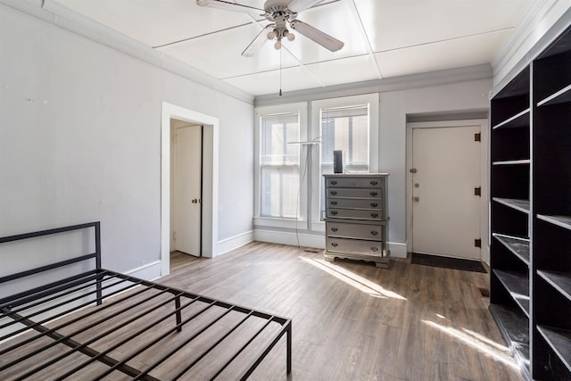 unfurnished bedroom with hardwood / wood-style floors, ceiling fan, and crown molding